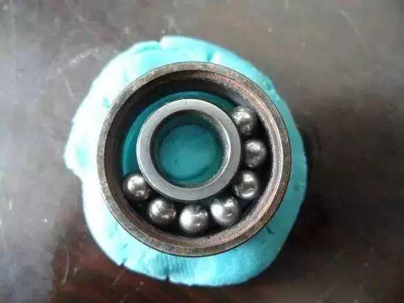 隨后將內圈擠到鋼珠那邊，使鋼珠卡在凹槽中間